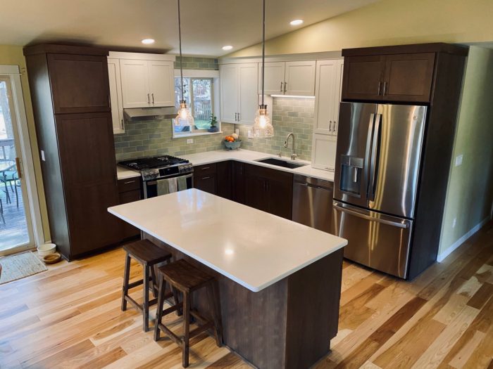 Contemporary kitchen remodel to update color scheme, textures and appliances. Wing walls removed to open the space and added new and more mood lighting to brighten. Hickory hardwood flooring, modern cabinets installed, quartz countertops and handmade subway ceramic backsplash tiling. Materials chosen for contrast and complimenting textures. Functionally, quartz as a countertop reigns supreme as do many other design features in this stylish central Oregon open floor plan family kitchen. Builder, remodel, kitchen remodel, carpentry, wood working, tile work, wood floor, custom design, rebuild, handmade tile, quartz countertop
