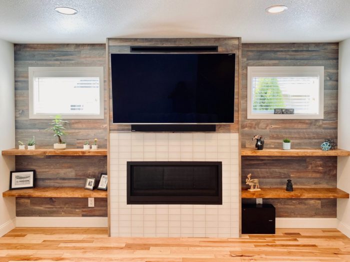 Heat efficiency and ambiance focused fireplace update to accommodate contemporary aesthetics, media mount, bump out design and room balance. Glass subway tile matched from the adjoining kitchen remodel. Shelves handmade on site in Bend Craftsmen Company shop. Modern fireplace venting system to allow flexibility with electrical component placement. Builder, remodel, living room remodel, carpentry, wood working, tile work, custom design, rebuild, fireplace, bump out, wood shelves